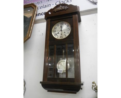 A 1930's wall clock with 3 bevelled glass panels