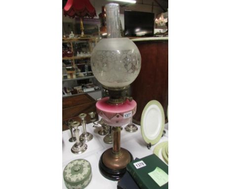 An antique cranberry milk glass double burner oil lamp & shade