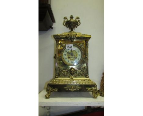 Ornate brass mantle clock with dragon urn top and lion masks to sides