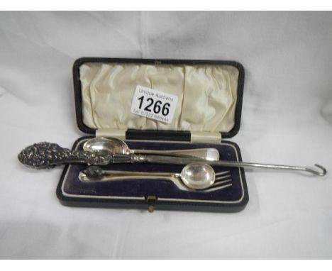 A cased silver spoon and fork, another silver spoon and a silver handled button hook
