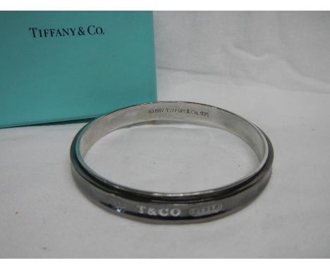 A Tiffany &amp; Co., 925 sterling silver bangle in box and a miniature pocket watch