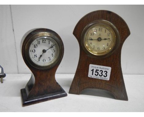 A small mahogany balloon clock and an arts and crafts clock