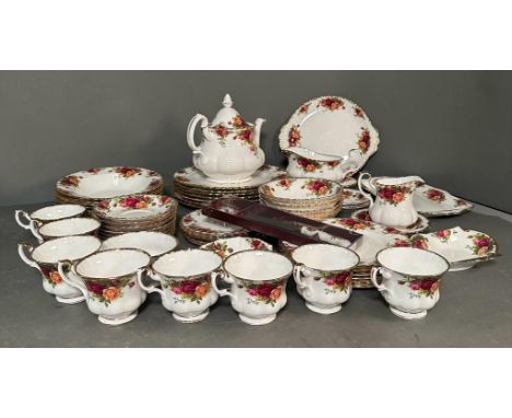 A Royal Albert tea/dinner service in "The Old Country Rose" pattern. To include cups, saucers, tea pot and various sizes of p