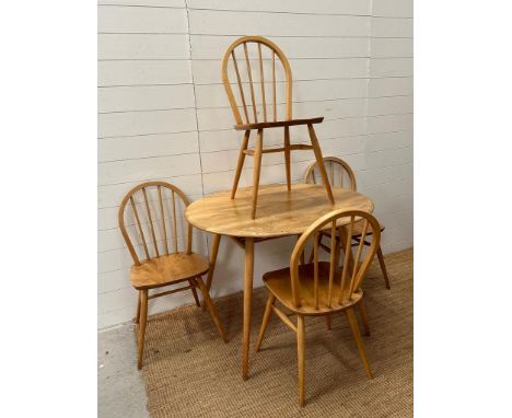 A Circular blonde Ercol table and chairs