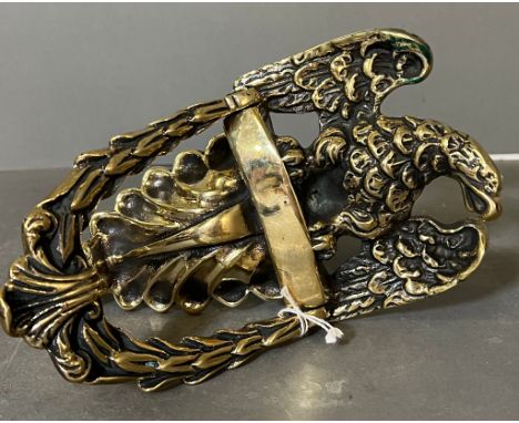 A brass eagle themed door knocker.