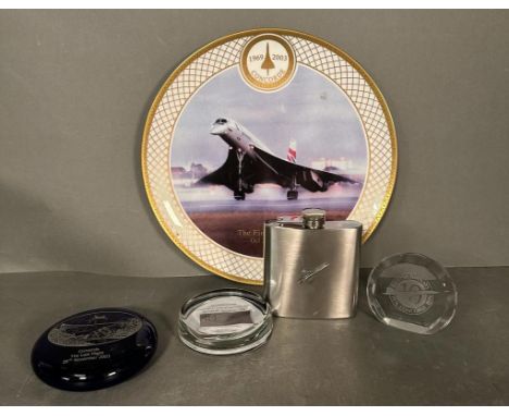 Concorde interest: Three commemorative Concorde paperweights, a Concorde hip flask a commemorative plate by Royal Worcester o
