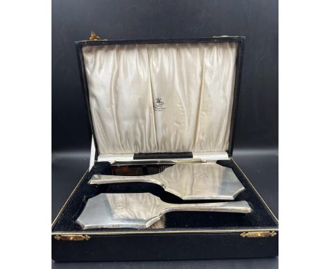 A boxed set of silver dressing table brush, mirror and comb with GE engraving, hallmarked for Birmingham 1929 by S Blanckense