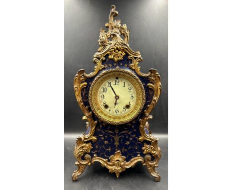 A Rococo style mantel clock with enamel face in royal blue with gilt fleur detail 