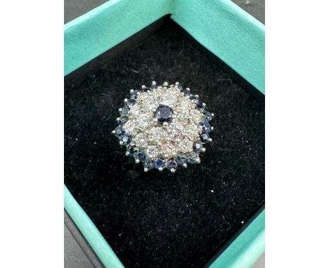 A diamond and sapphire cluster ring on an 18ct white gold setting Size Q
