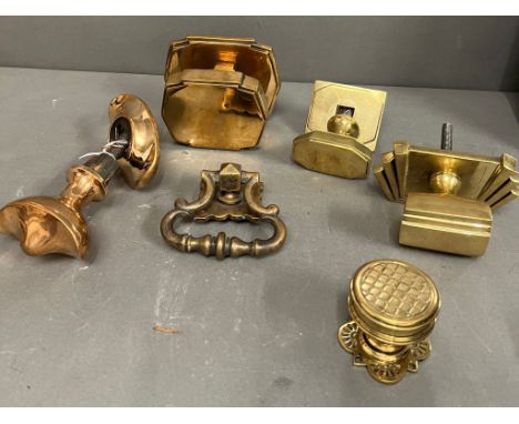 A selection of antique brass door furniture to include three Art Deco door pulls, a boat shape centre pull by JCES, door knoc