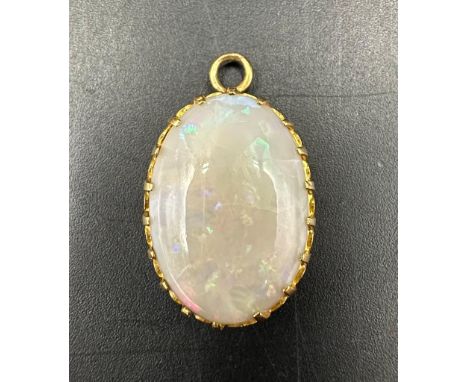 An opal pendant in a yellow gold setting AF