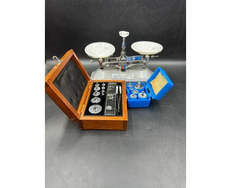 A set of Tricle Brand table balance scales and two boxes of stainless steel weights 