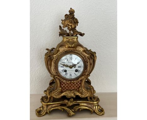 An ornate French mantle clock, eight day by Costain Galerie de la Madeleine Paris.