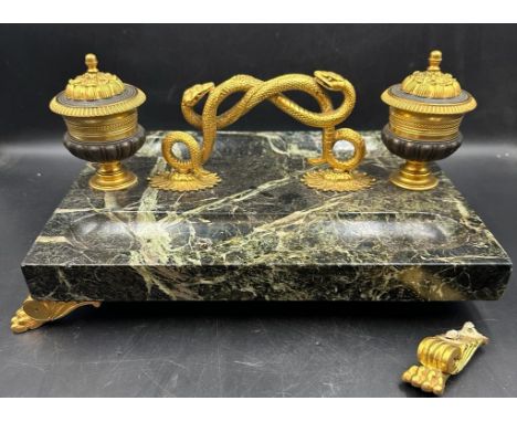 An inkwell in bronze and marble on lion paw feet with twisted snake handle (One foot needs reattaching)