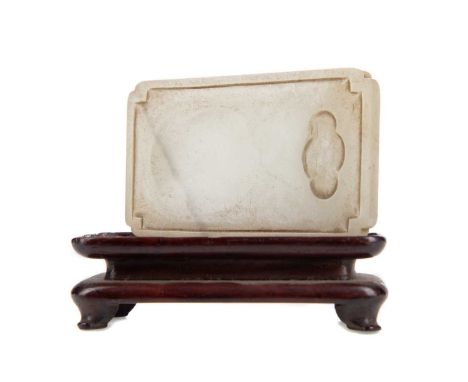 CHINESE PALE CELADON JADE INKSTONE,of oblong form with concave corners, central groove for grinding ink, below a quatrefoil w