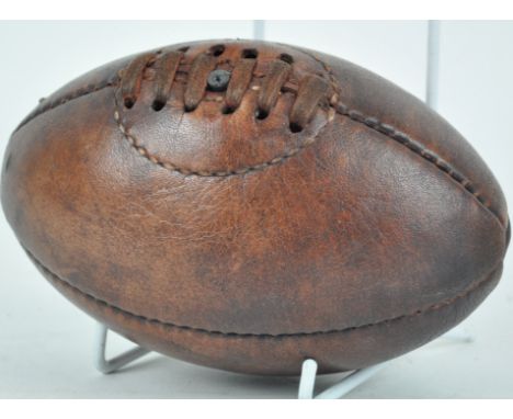 A miniature leather vintage style rugby ball, 16cm high