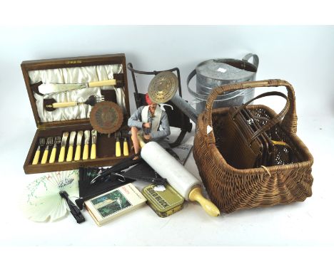 A watering can, a basket, a rolling pin and other items