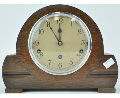 An oak cased mantel clock