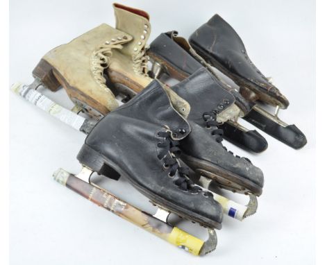 A pair of vintage racing skates together with two other pairs of ice skates