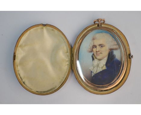 A Georgian portrait miniature on ivory of a gentleman with grey wig and blue coat, 7.6 x 5.7 cm, in gilt metal frame with sus