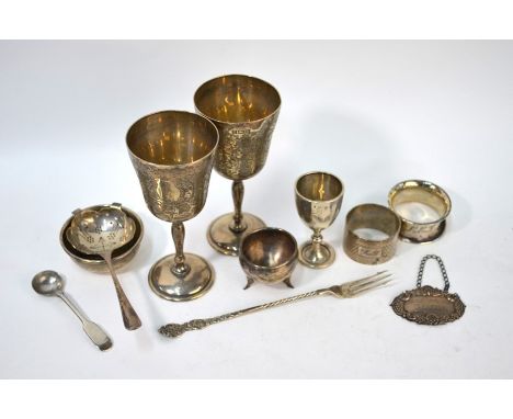 Various oddments of silver, including a pair of foliate engraved goblets, Birmingham 1971, a tea-strainer on stand, cauldron 
