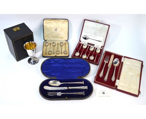 A cased silver goblet, Mappin &amp; Webb, London 1973, two cased sets of coffee spoons and two cased Christening knife, fork 