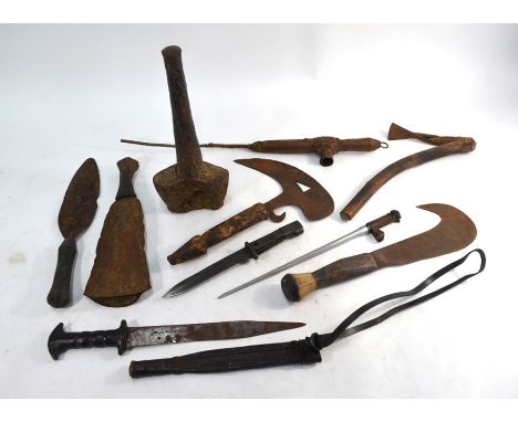 A collection of old African 'tools of the land', including adse, knives, axe, anvil to/w three bayonets