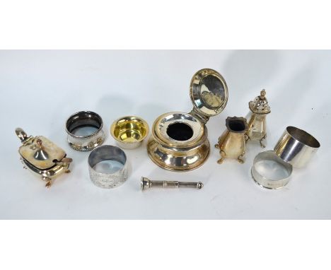 An engine-turned silver cigar-piercer, William Manton, Birmingham 1975, three silver napkin rings and three condiments, 4.5 o