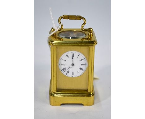 A miniature lacquered brass carriage clock, the white enamelled dial within a plain brass mask, 7.5 cm h&nbsp;good/undamaged 
