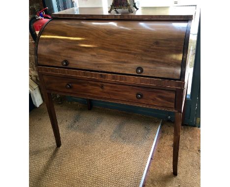 A 19th century mahogany cylinder top writing desk, the slide top fitted with rise/fall leather inset surfaces and stationery 