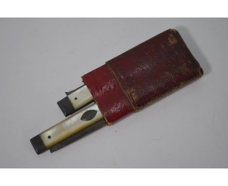 A Georgian silver folding knife and fork set, with mother-of-pearl handles, assay and duty marks only, in red Morocco leather