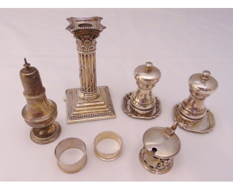 A quantity of hallmarked silver to include a mustard pot, two napkin rings, a sugar sifter, a pair of salt and pepper grinder