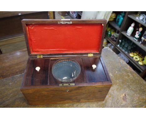 An early 19th century rosewood tea caddy, the interior with original glass mixing bowl, 31cm wide. 