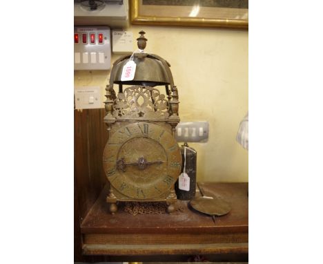 An antique brass lantern clock,&nbsp;with 6 1/4in dial and single hand, 38.5cm high, with weight and pendulum. 