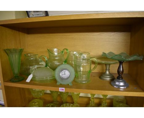 A collection of green uranium glass.&nbsp;(one shelf) 