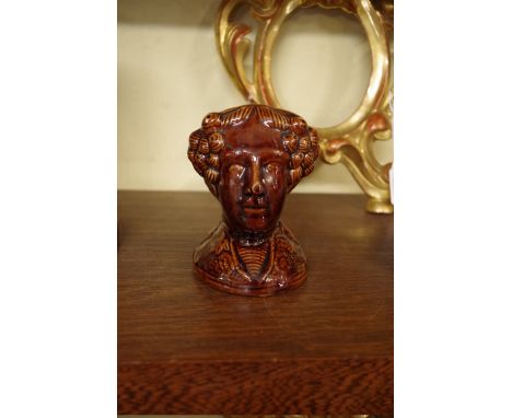 A 19th century treacle glazed figural sash window stops.&nbsp; 