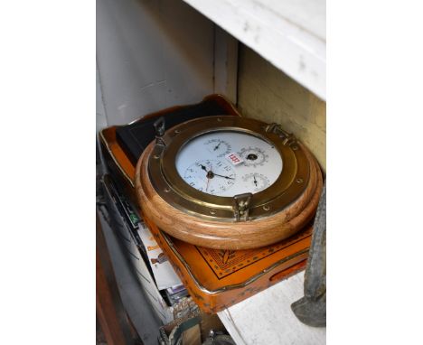 A novelty brass and oak framed ship's porthole combined clock and barometer,&nbsp;35cm diameter; together with a twin handled