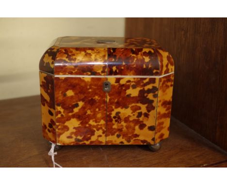 A Regency tortoiseshell tea caddy, on white metal bun feet, 15.5cm wide. 
