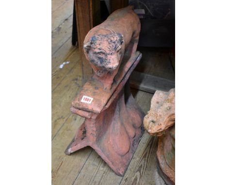 A red composition stone Bull roof ridge tile, 37.5cm wide. 
