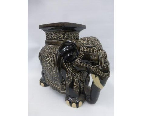 A black ceramic conservatory seat in the form of an elephant.