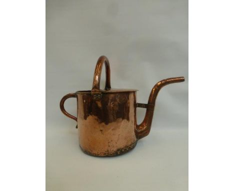 A Victorian copper watering can for a traction engine.