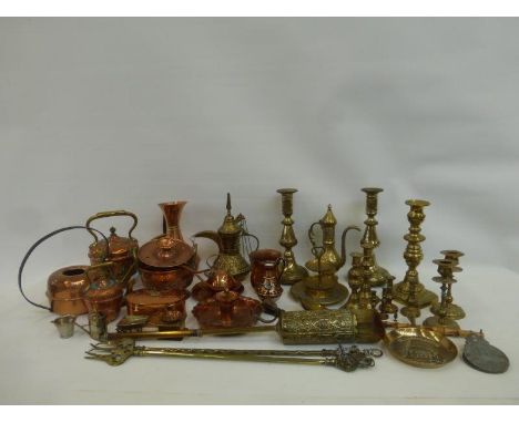 An assortment of copper and brassware, including a 19th Century brass candlestick.