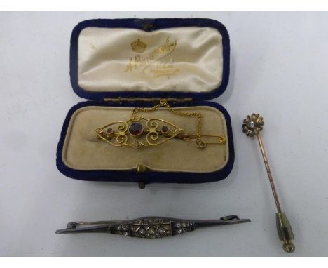 A 9ct gold bar brooch set with seed pearls and garnets, a silver bar brooch and a diamond and seed pearl tie pin.