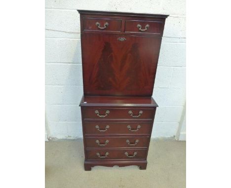 A contemporary mahogany secretaire cabinet, the fall front with a fitted interior above a four drawer base, raised on bracket