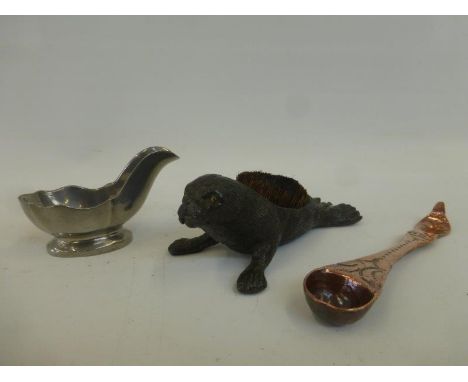 A cast pewter Dunhill Crown and Rose pipe rest, a 19th Century pewter nib wipe in the form of a sea lion, and an early 19th C