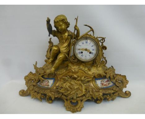 A large gilt 19th Century table clock mantle clock depicting a cherub with a fishing rod, fish and anchor sat on a boat above