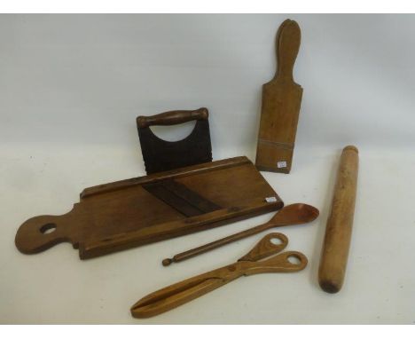 An assortment of 19th Century and later wooden kitchenalia including a sycamore mandaline, rolling pin, butter pats, etc.