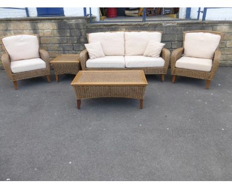 A five piece wicker and cane conservatory suite comprising a sofa, two elbow chairs, a side table and a coffee table.