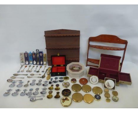 An assortment of collector's spoons, tea caddy spoons, compacts and pill boxes. Also with two tea spoon display racks.