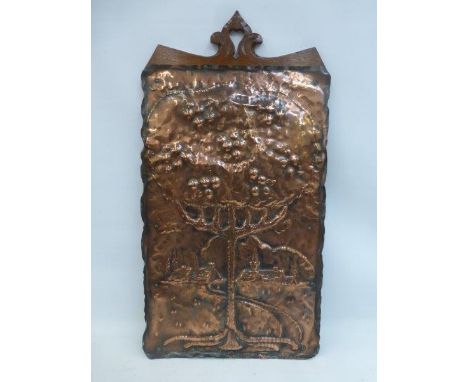 A Folk Art/Arts and Crafts hand beaten copper panel depicting a tree with apples and a backdrop of cottages.